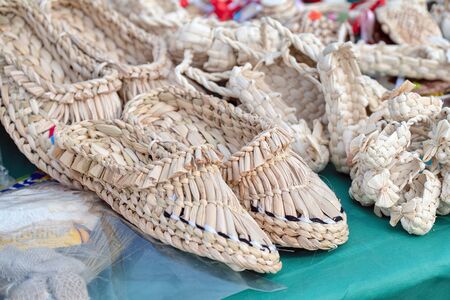 Souvenir bast shoes woven from bast. Old traditional Russian shoesの写真素材