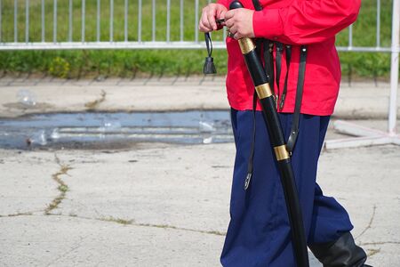 Cossack in a red shirt and trousers holds a cavalry checker in his handsの写真素材
