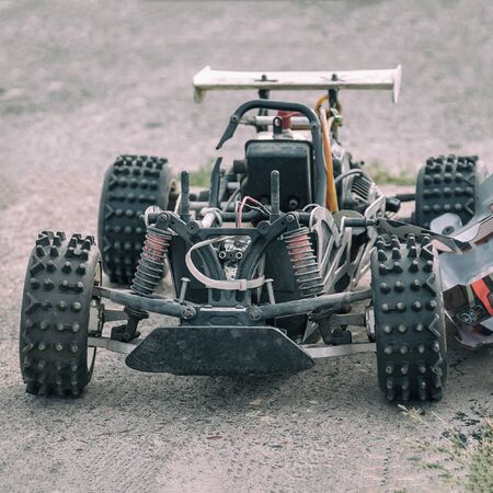 Disassembled RC model racing cars. Model cars without top. Radio controlled car model frame
