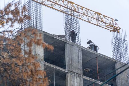 Builder on the construction site of a house under construction. Soft focus