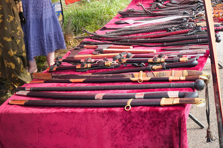 Samara , Russia - August 17, 2019: Cossack sabers in scabbard and braided lashes on the tableのeditorial素材