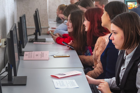 Chapaevsk, Samara region, Russia - January 31, 2020: College in Chapaevsk city. Female students in front of computers in a computer class. Soft focusのeditorial素材