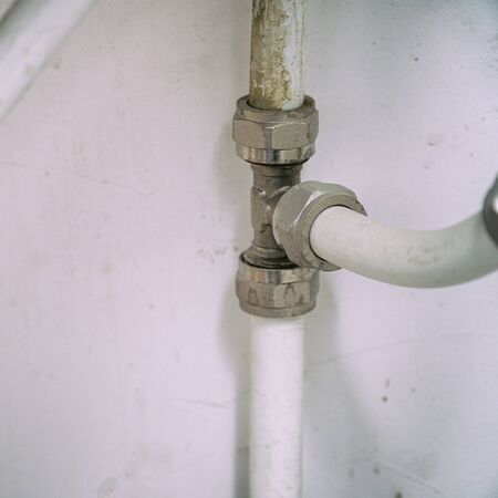 Old connection fitting tee on plastic water pipes