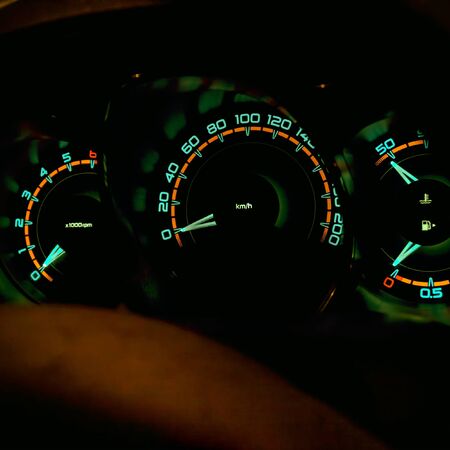 Speedometer in the car on the dashboard at night. Selective focus
