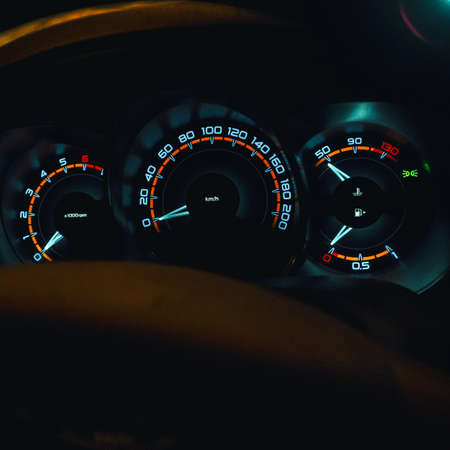 Speedometer in the car on the dashboard at night. Selective focusの写真素材