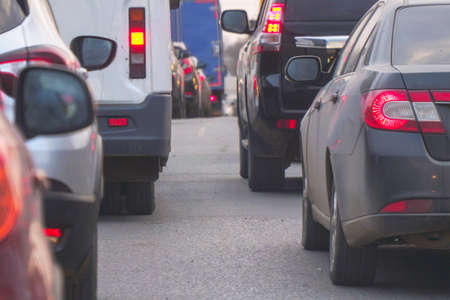 Cars standing in a traffic jam on a city streetの写真素材