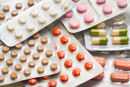 Different Colored tablets and capsules Packed in blisters.の写真素材
