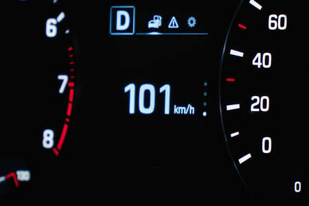 Speedometer in the car on the dashboard. The cars speedometer shows 101 mph