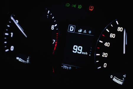 Speedometer in the car on the dashboard. The cars speedometer shows 99 mphの写真素材