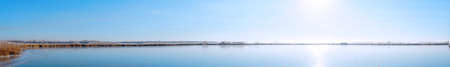 Panorama Sun over a frozen winter lake. Fabulous Winter landscapeの写真素材