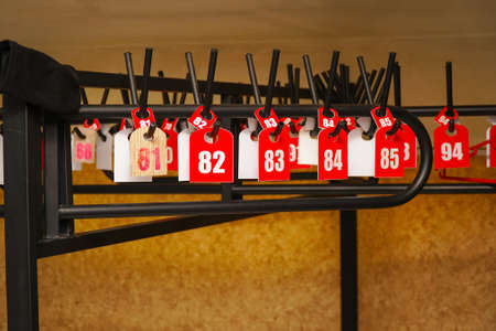 Empty hangers with numbers in theater or other public placeの写真素材