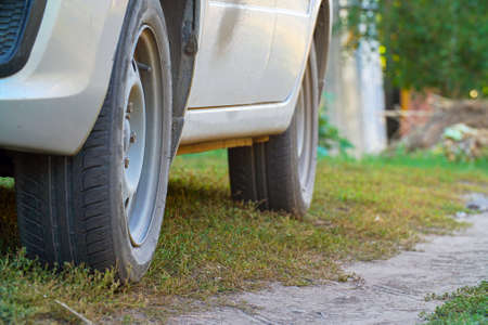 Wheels of a car standing on dirt roadの写真素材