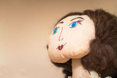 The face of a homemade rag doll with blue eyes. Portrait of a rag dollの写真素材