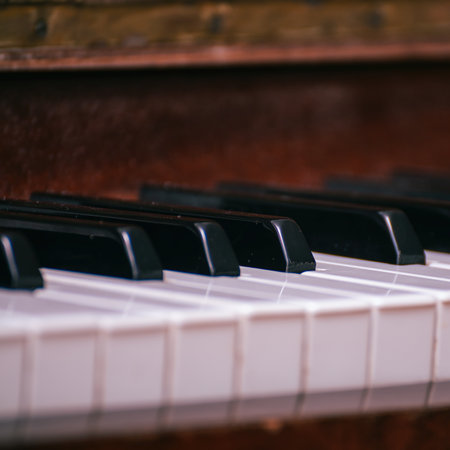 A fragment of the keyboard of an old piano. Black and white keys of an old piano
