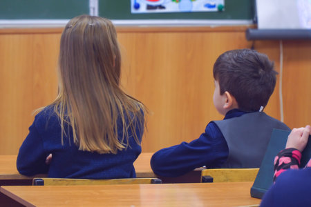 Little schoolgirl and schoolboy at the Desk