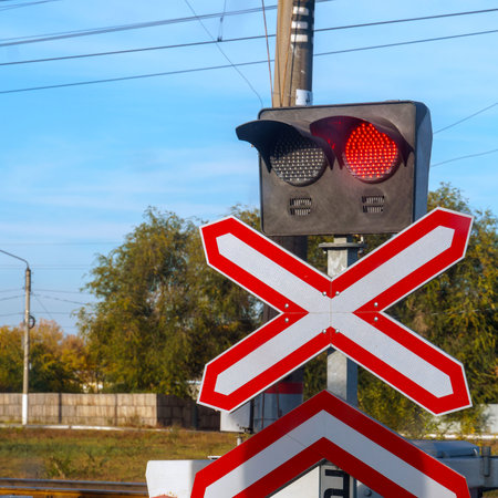 Traffic light or semaphore flashing red at railway crossingの写真素材