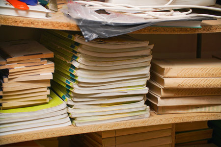 Stacks of books on a shelf in the libraryの写真素材