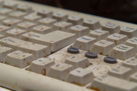A fragment of a dirty and dusty computer keyboard close-up