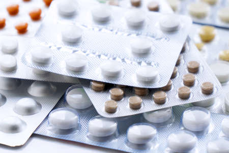 Overall view of pharmaceutical tablets and capsules in packages in assortment. Tablets in a blisterの写真素材