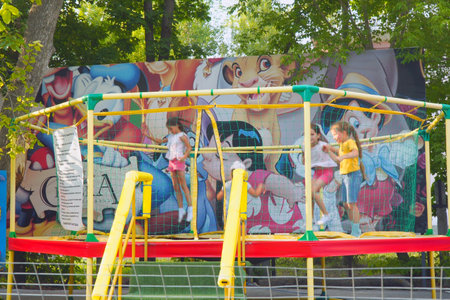 Samara, Russia - October 04, 2021: Children jump on a trampoline in the park on the playgroundのeditorial素材