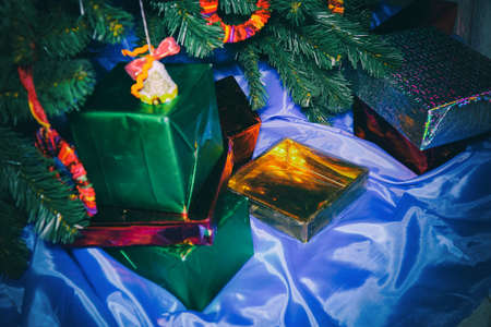Christmas and New Year gifts in beautiful boxes under the Christmas treeの写真素材