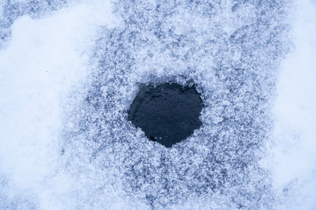 Ice hole in the ice for winter fishingの写真素材