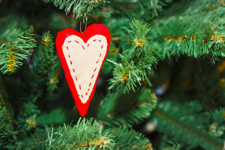 Homemade heart sign on Christmas treeの写真素材