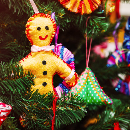 Homemade man-cookie on a New Years Christmas tree. Handmade Christmas decorationsの写真素材