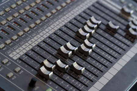 Faders and control buttons on the mixing console. Selective focusの写真素材