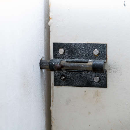 Steel latch on the white entrance doorの写真素材