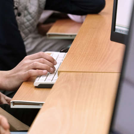 Students hands at the computer keyboard in the computer classroom