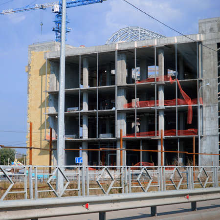 Construction crane at Unfinished building under constructionの写真素材