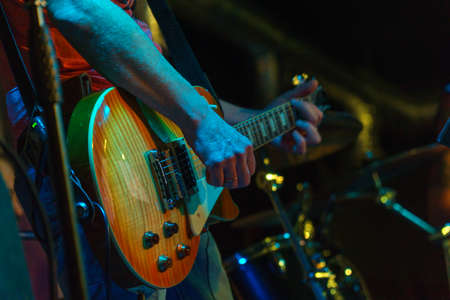 The guitarist plays on guitar. Hands of a Guitar player playing the guitar. Selective focus. Soft focusの写真素材