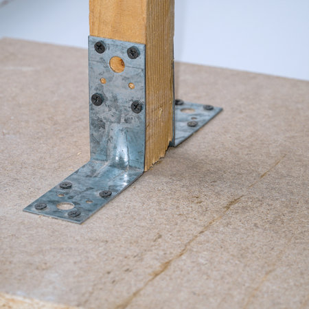 Connection of wooden parts with a metal plate with screwsの写真素材