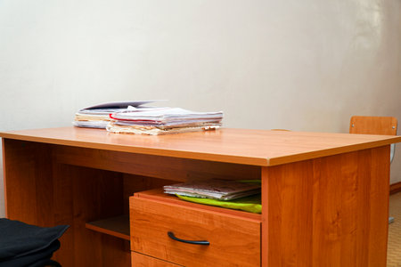 A stack of papers on a desktop without a computerの写真素材