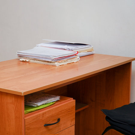 A stack of papers on a desktop without a computerの写真素材