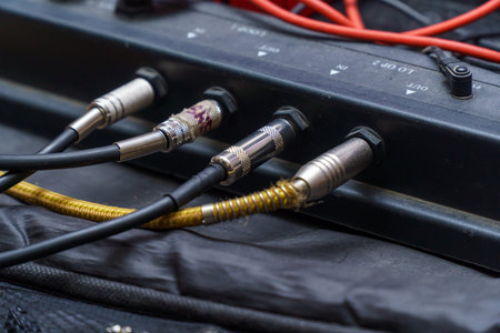 Audio jacks are plugged into a guitar synthesizer or processorの写真素材