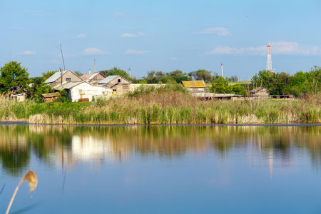 View of the village pond and houses on the shoreの写真素材
