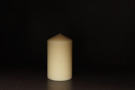 White candle on a dark backgroundの写真素材