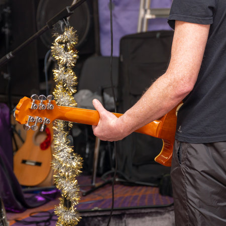 A guitarist plays the guitar at the rehearsal. Rear viewの写真素材
