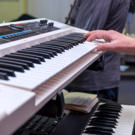 A pianist or keyboardist plays a synthesizerの写真素材