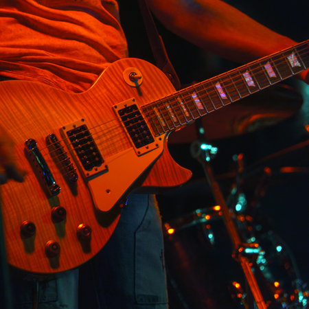The guitarist plays on guitar. Hands of a Guitar player playing the guitar. Selective focus. Soft focusの写真素材