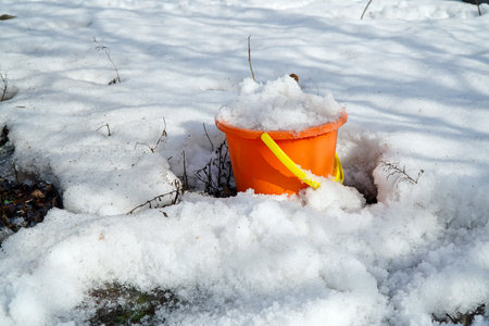 Melting snow in a bucketの写真素材