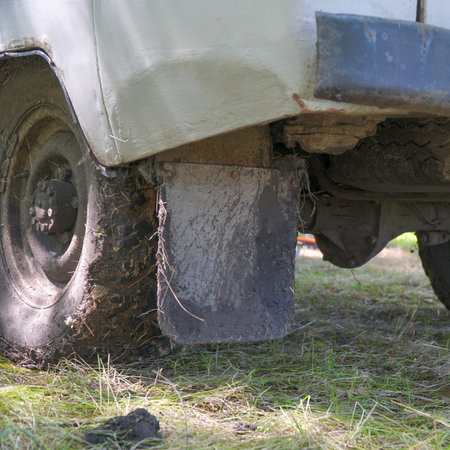 Dirty wheels of off-road car on natural background