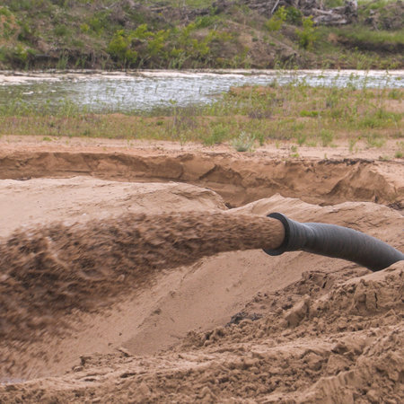 Dirty water is flowing from the pipe. Sand miningの写真素材