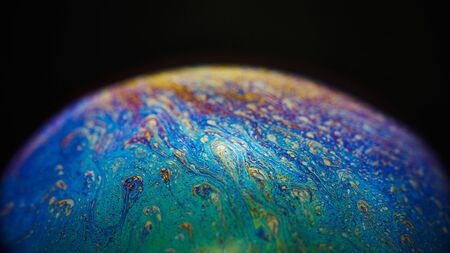Soap bubble on dark background. Lots of colors and magical texture was created thanks to strong...