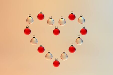 A heart shape made out of Christmas baubles. Christmas ornament.