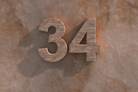 Number 34 embossed or carved from marble placed on a matching marble baseの写真素材