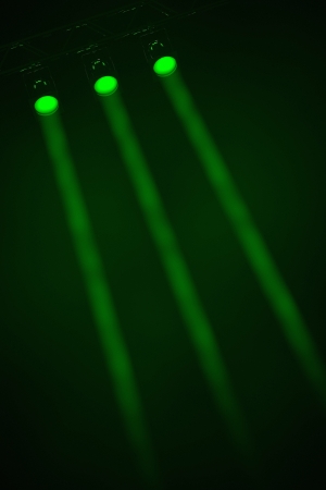 Three parallel individual narrow beamed green spotlights shining through smoky darkness at an oblique angle from the top left of the frameの写真素材