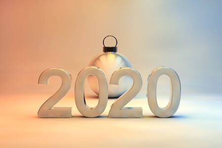 2020 New Year date in 3d numerals with a shiny Christmas bauble on a soft muted background graduating from blue through to orange with copyspace for your seasonal greetingの写真素材